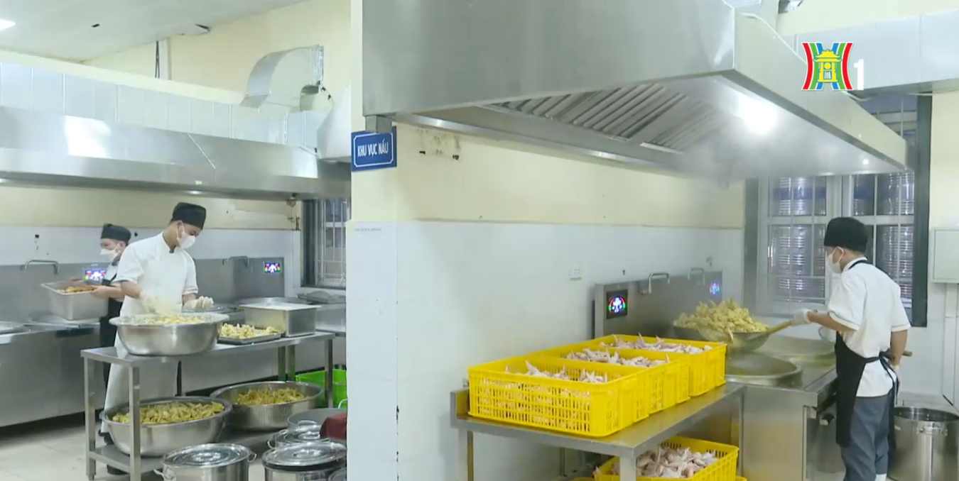 Không gian bếp ăn bán trú rộng rãi, nhân viên tuân thủ nghiêm ngặt trang phục bảo hộ lao động.